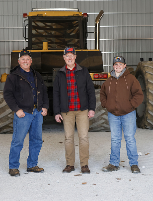 Greg Goode standing with Indiana farmers in front of a tractor